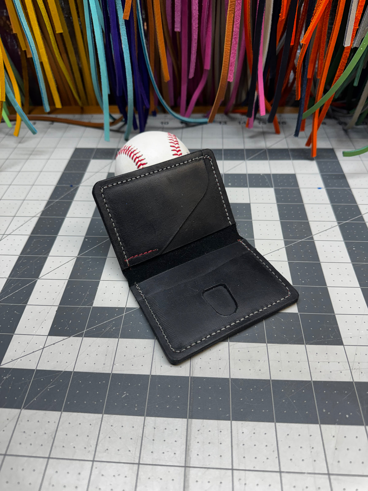 Black Rawlings baseball wallet with gold patch