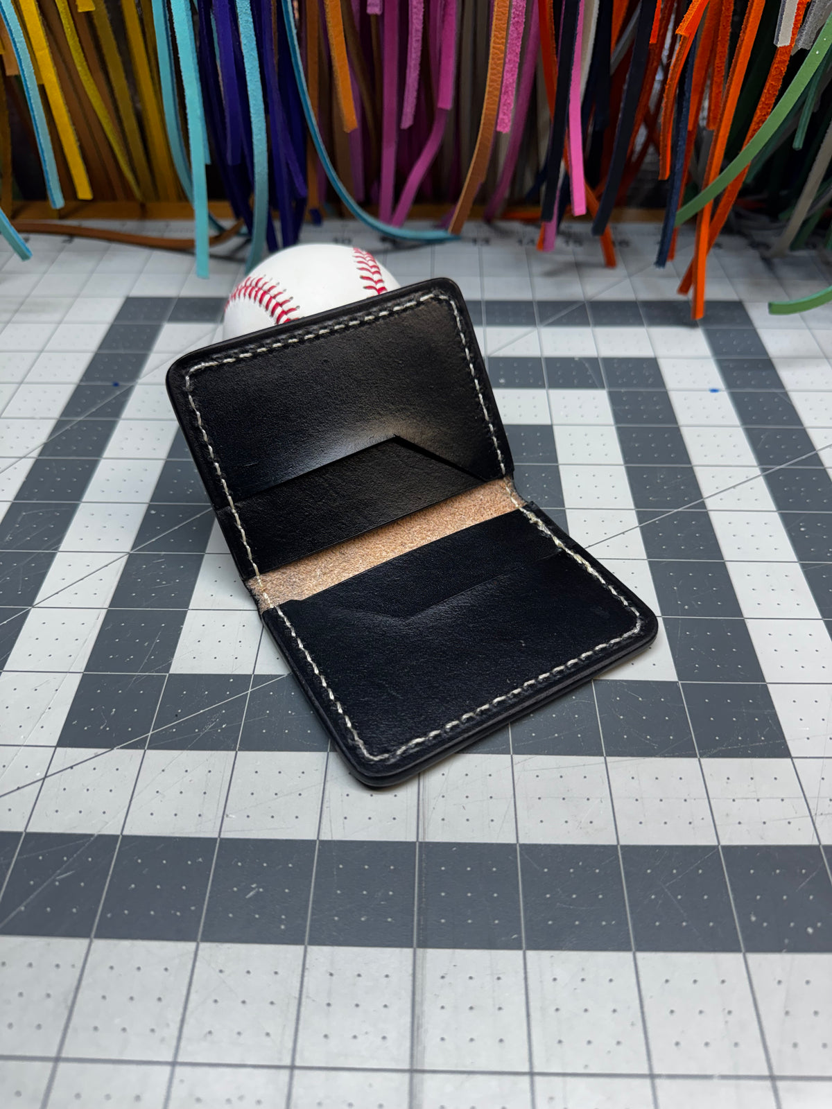 Black leather Rawlings baseball wallet with genuine glove patch