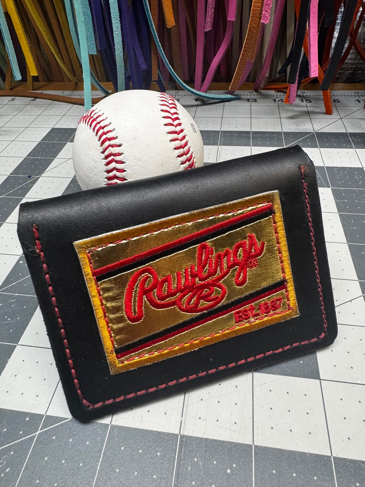 Gold Rawlings patch on handmade black baseball wallet
